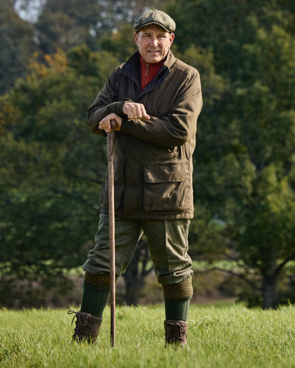 Willow Green Coloured Harkila Pro Hunter Shooting GTX Jacket on forest background #colour_willow-green