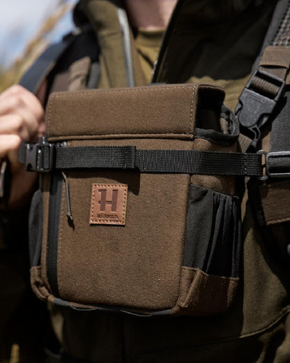 Willow Green Coloured Harkila Ragnar First Aid Backpack on blurry background #colour_willow-green