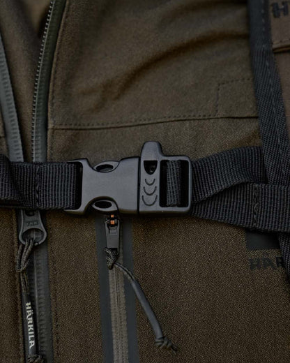 Willow Green Coloured Harkila Ragnar First Aid Backpack on blurry background #colour_willow-green