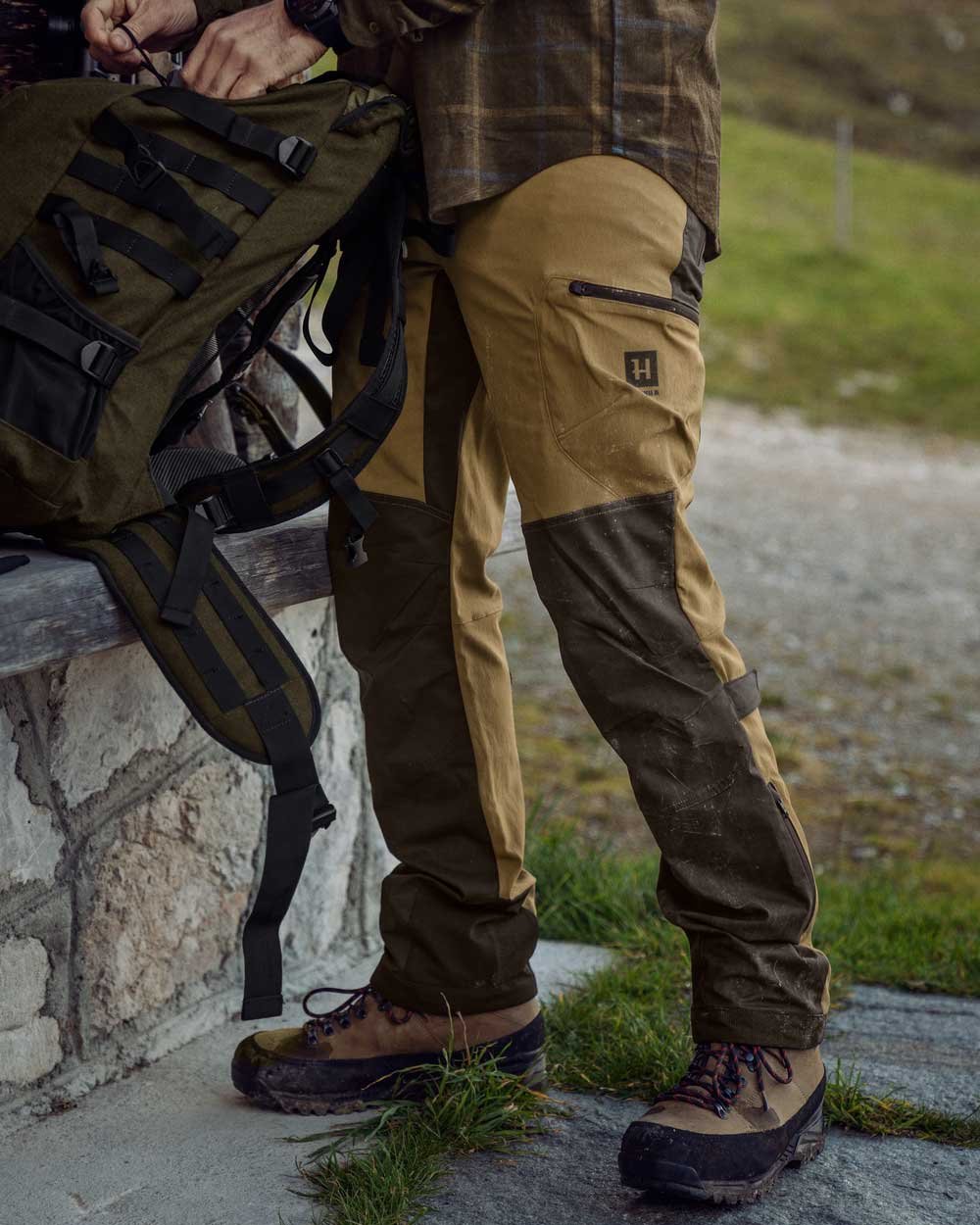 Shadow Brown Golden Brown Coloured Harkila Ragnar Trousers on outdoor background #colour_shadow-brown-golden-brown