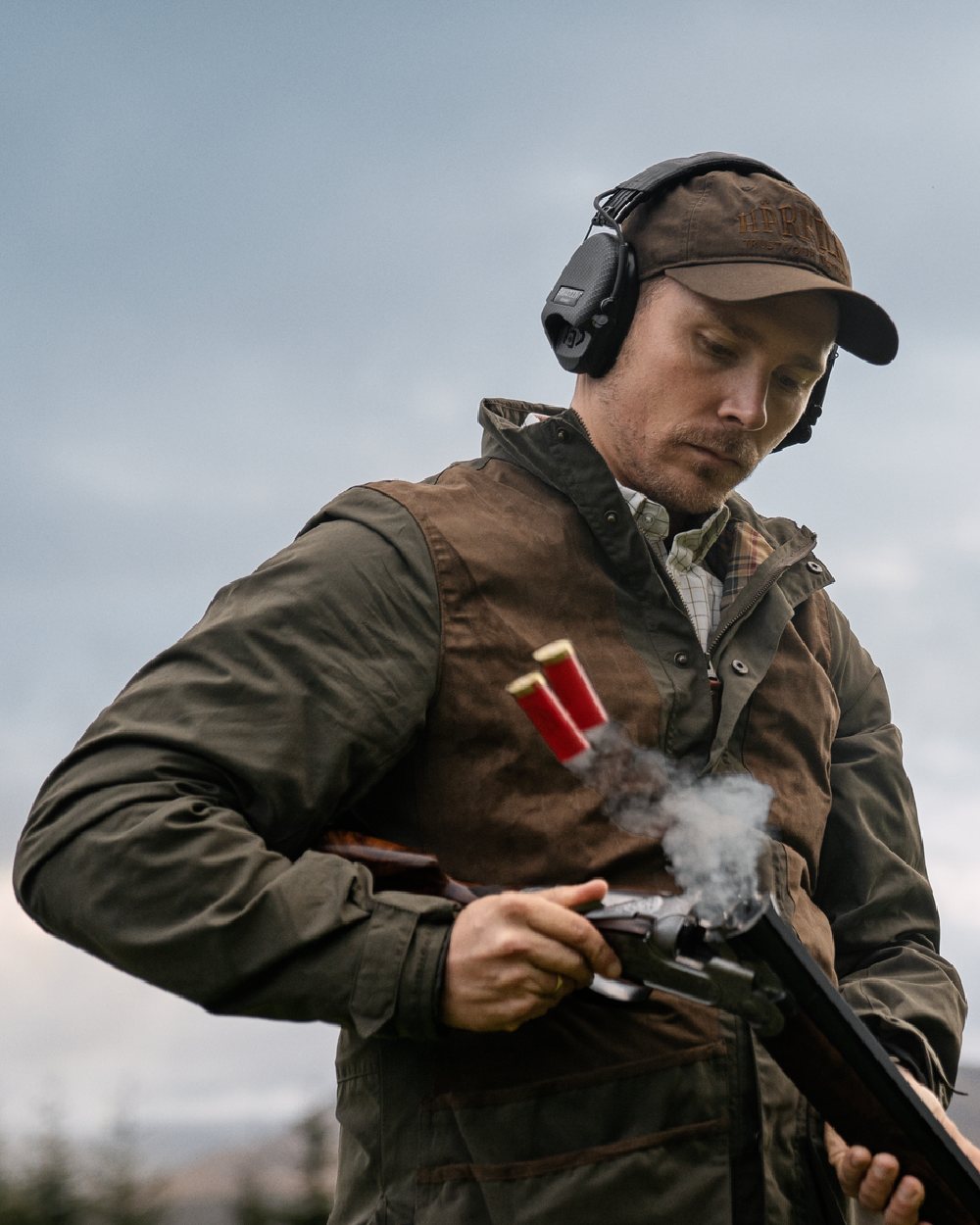 Willow Green Coloured Harkila Rannoch HWS Shooting Jacket on forest background #colour_willow-green