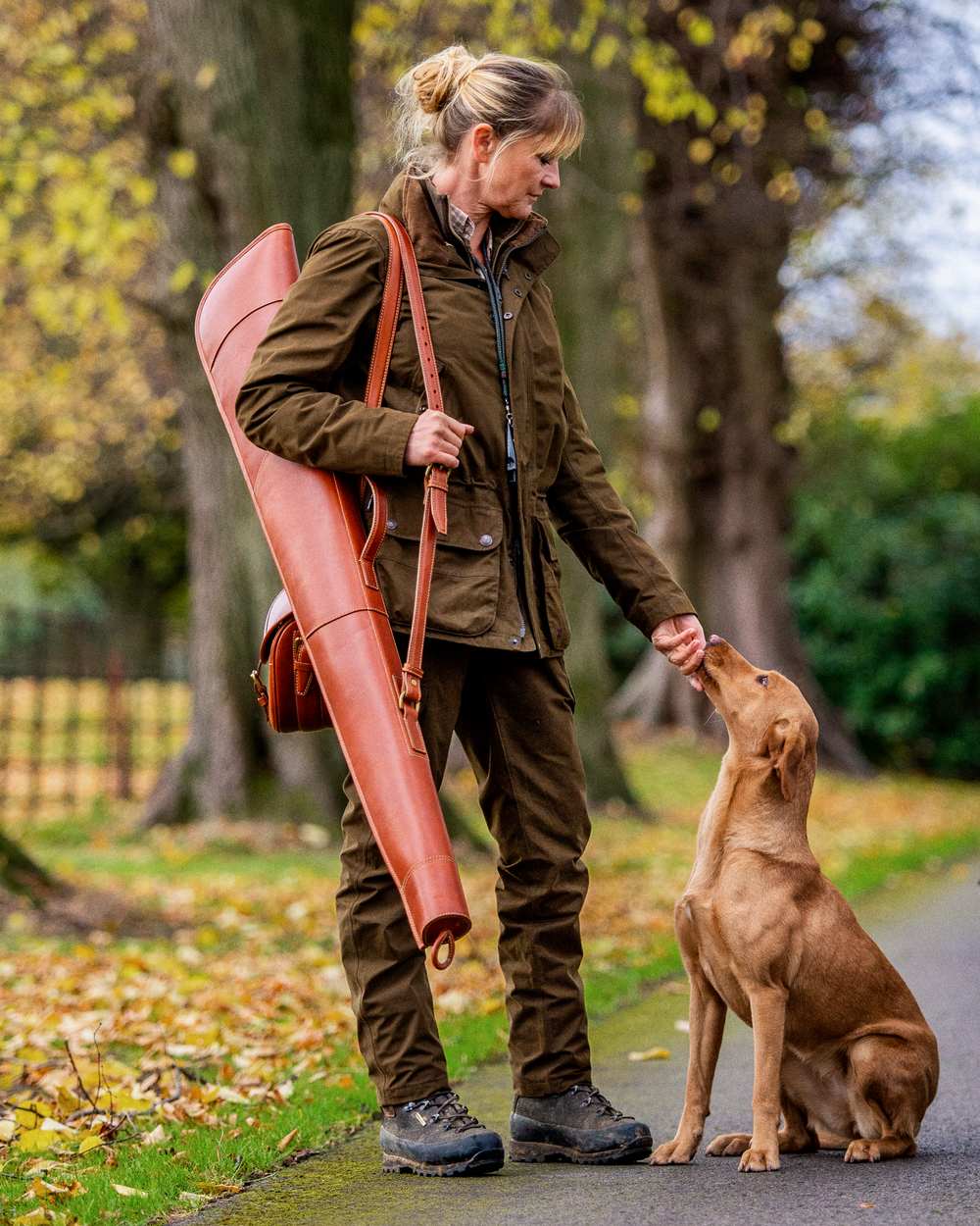Warm Olive Coloured Harkila Retrieve Lady Jacket on outdoor background #colour_warm-olive