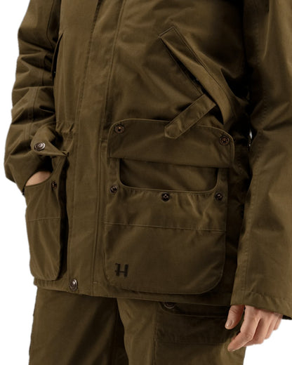Warm Olive Coloured Harkila Retrieve Lady Jacket on white background #colour_warm-olive