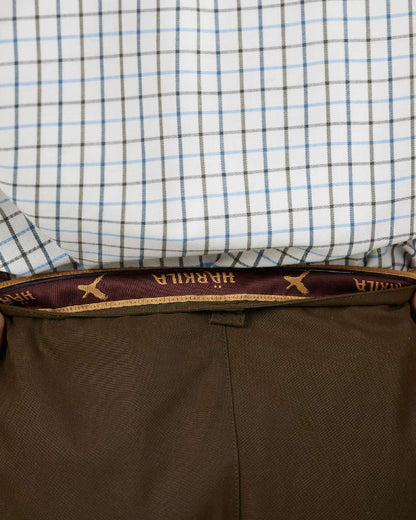 Dark Warm Olive Coloured Harkila Retrieve Light Trousers on white background #colour_dark-warm-olive