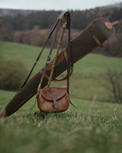 Warm Olive Coloured Harkila Retrieve Shotgun Slip on forest background #colour_warm-olive