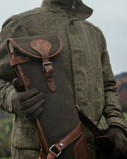 Warm Olive Coloured Harkila Retrieve Shotgun Slip on blurry background #colour_warm-olive