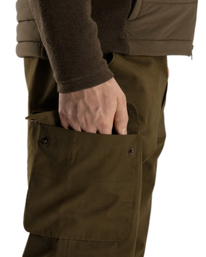 Warm Olive Coloured Harkila Retrieve Trousers on white background #colour_warm-olive