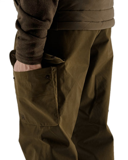 Warm Olive Coloured Harkila Retrieve Trousers on white background #colour_warm-olive