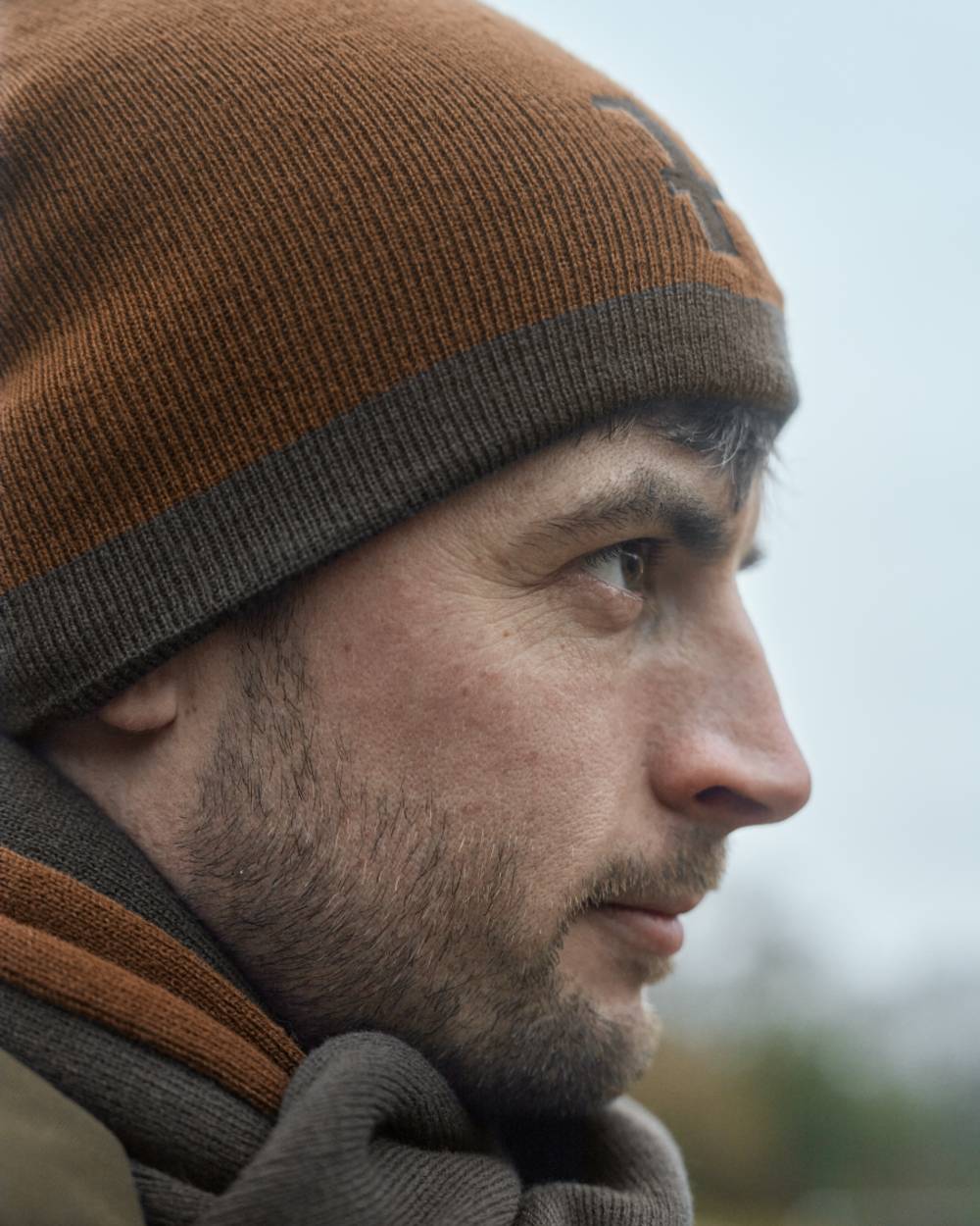 Shadow Brown Rustique Clay Coloured Harkila Reversible Beanie on outdoor background #colour_shadow-brown-rustique-clay
