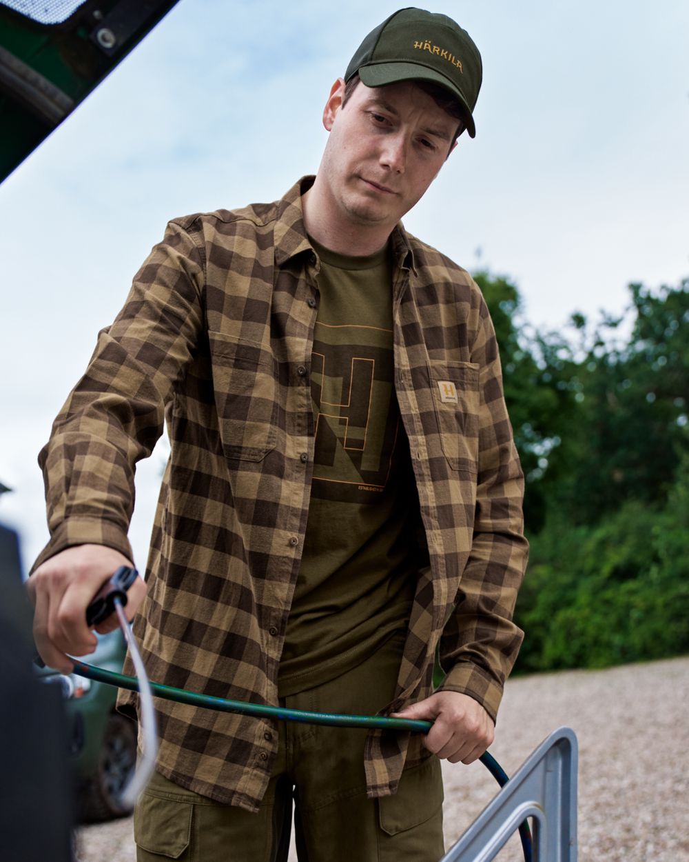 Antique Bronze Check coloured Harkila Scandinavian Long Sleeve Shirt on outdoor background #colour_antique-bronze-check