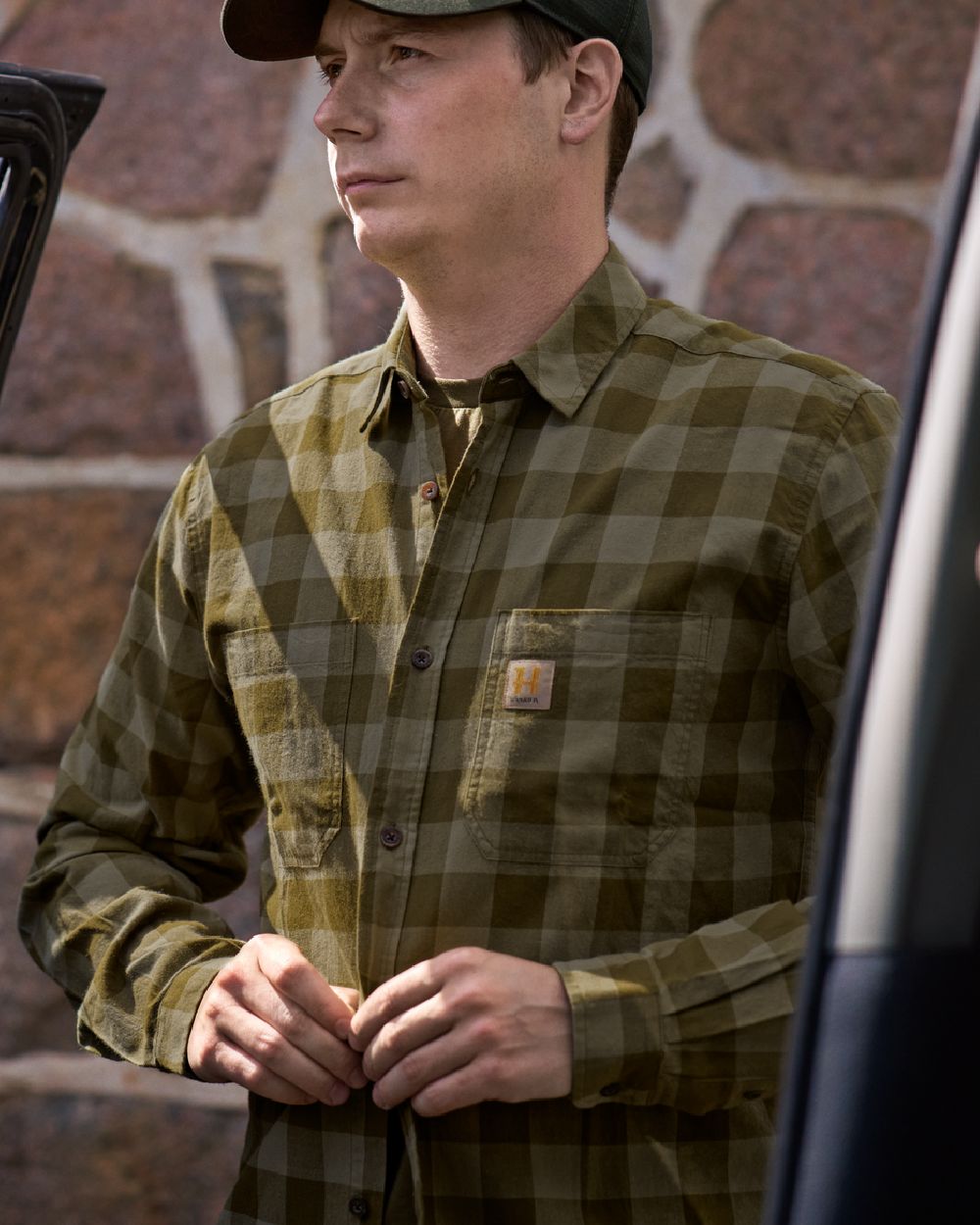 Dark Olive Check Coloured Harkila Scandinavian Long Sleeve Shirt on blurry background #colour_dark-olive-check