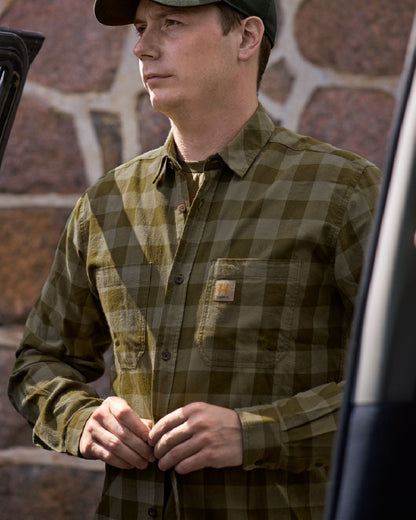 Dark Olive Check Coloured Harkila Scandinavian Long Sleeve Shirt on blurry background #colour_dark-olive-check