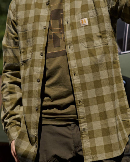 Dark Olive Check Coloured Harkila Scandinavian Long Sleeve Shirt on blurry background #colour_dark-olive-check