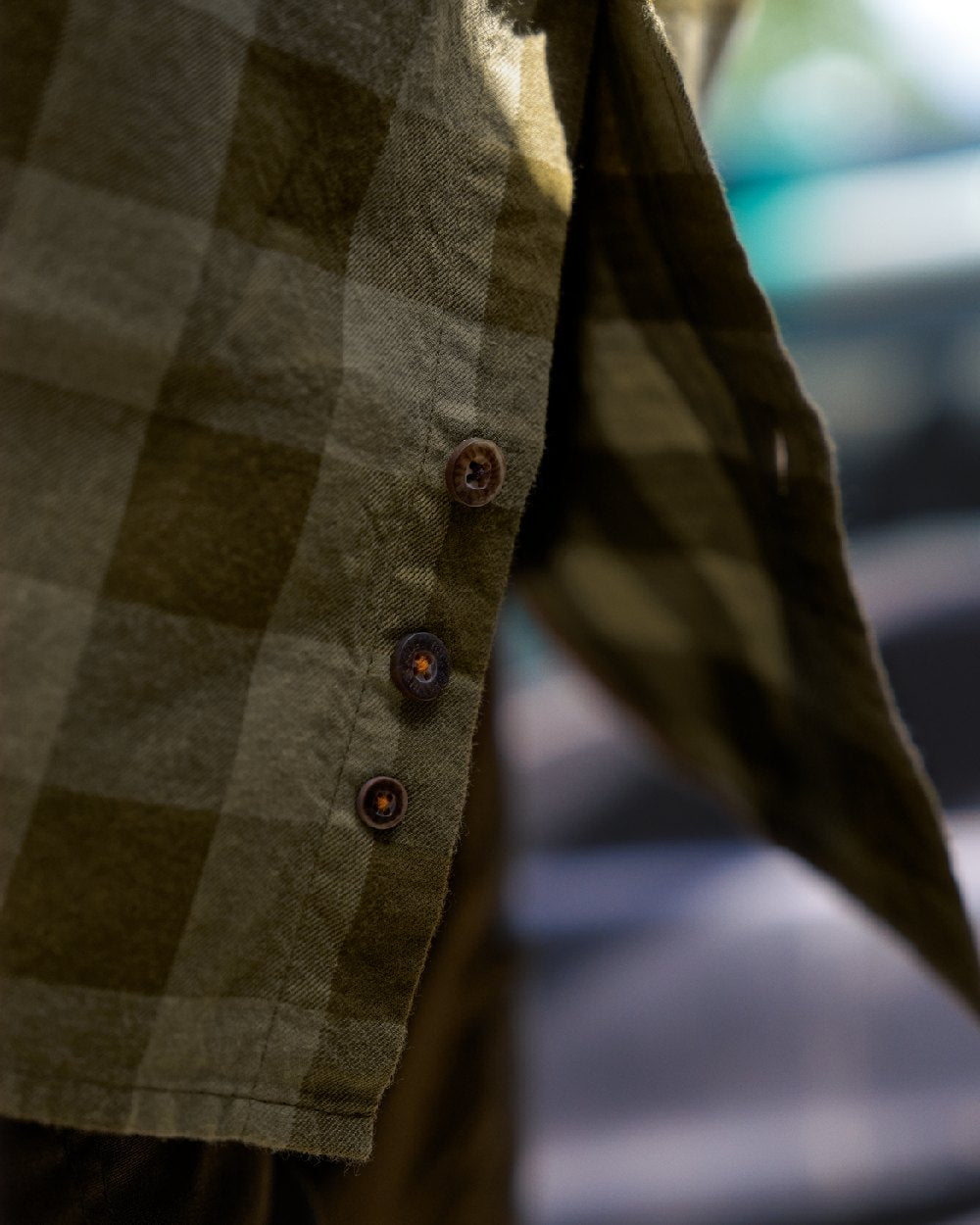 Dark Olive Check Coloured Harkila Scandinavian Long Sleeve Shirt on blurry background #colour_dark-olive-check