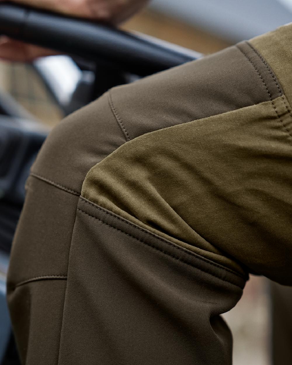 Dark Olive Willow Green Coloured Harkila Scandinavian Trousers on outdoor background #colour_dark-olive-willow-green