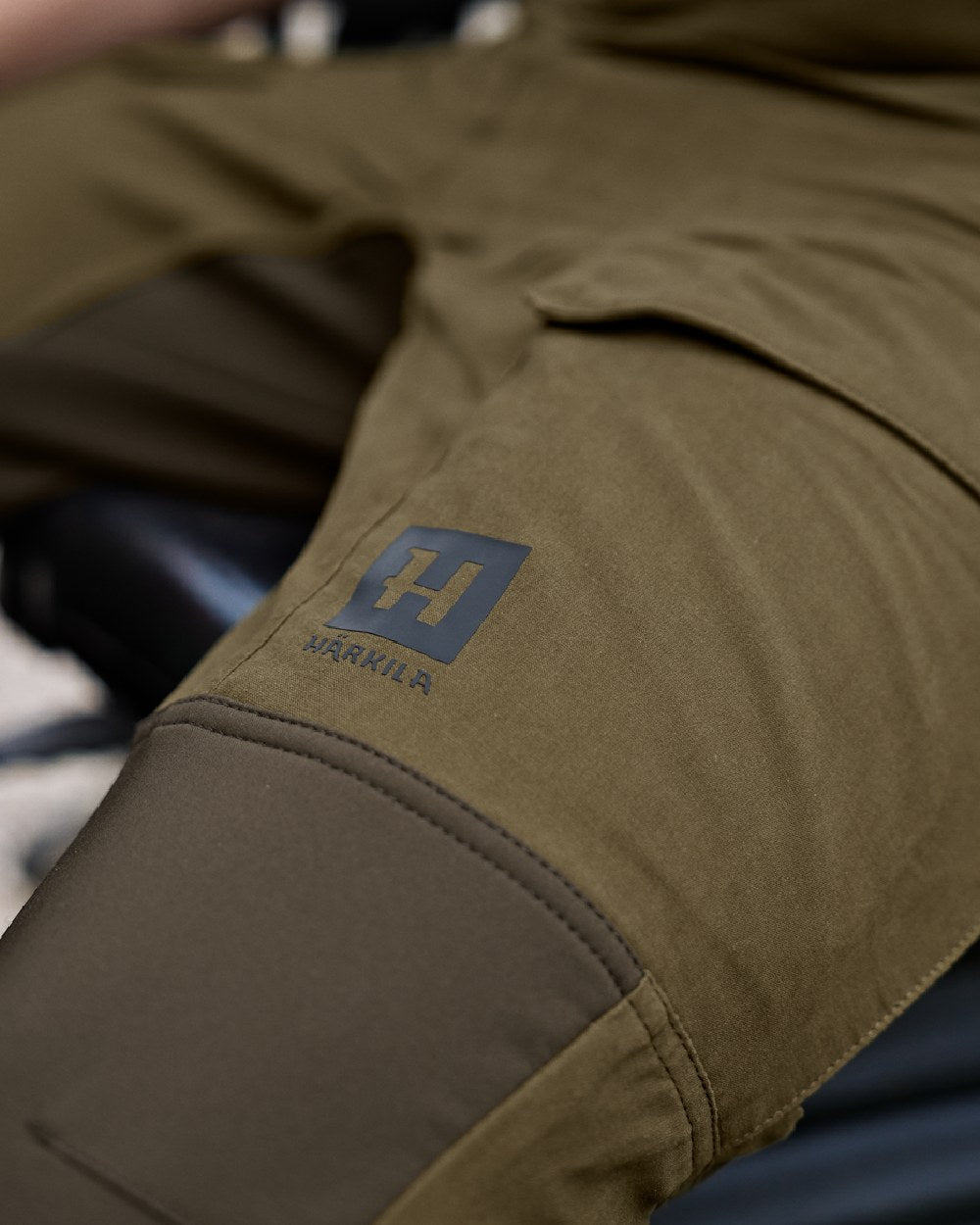 Dark Olive Willow Green Coloured Harkila Scandinavian Trousers on outdoor background #colour_dark-olive-willow-green