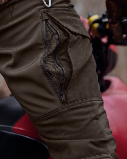Shadow Brown Deep Brown coloured Harkila Scandinavian Trousers on woodland background #colour_shadow-brown-dark-brown