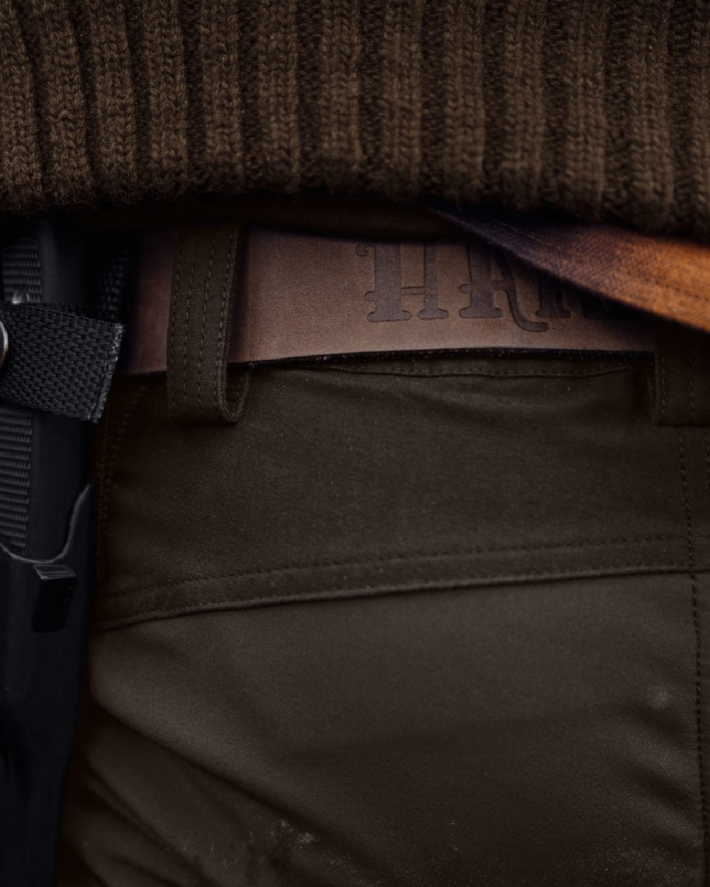 Shadow Brown Deep Brown coloured Harkila Scandinavian Trousers on woodland background #colour_shadow-brown-dark-brown