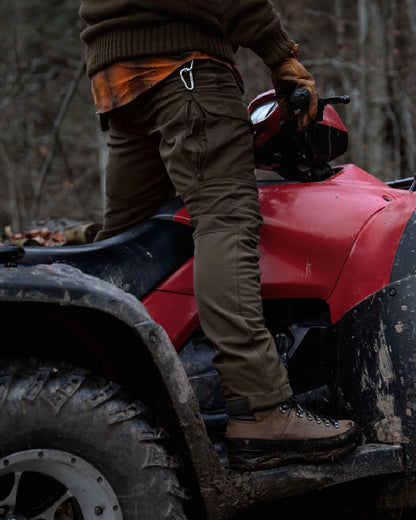 Shadow Brown Deep Brown coloured Harkila Scandinavian Trousers on woodland background #colour_shadow-brown-dark-brown