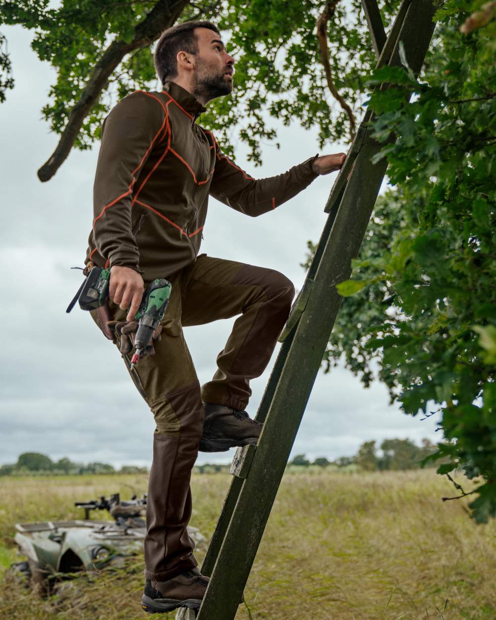 Willow Green Deep Brown Coloured Harkila Scandinavian Trousers on forest background #colour_willow-green-deep-brown