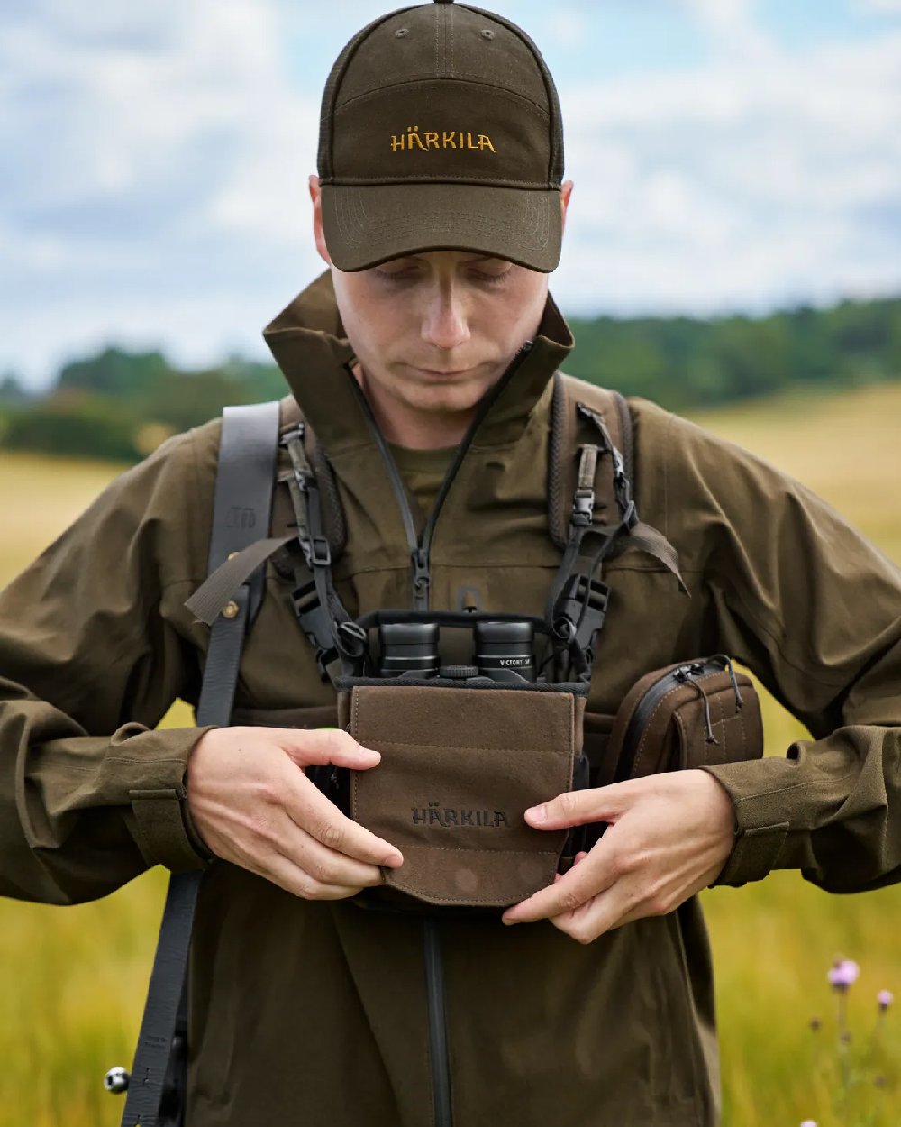 Dark Willow Green Coloured Harkila Utility Pouch on blurry background #colour_dark-willow-green