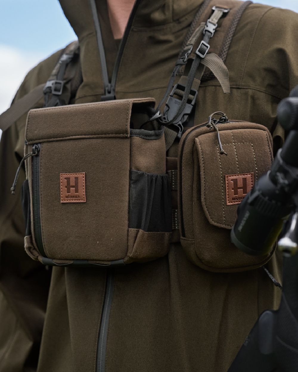 Dark Willow Green Coloured Harkila Utility Pouch on blurry background #colour_dark-willow-green