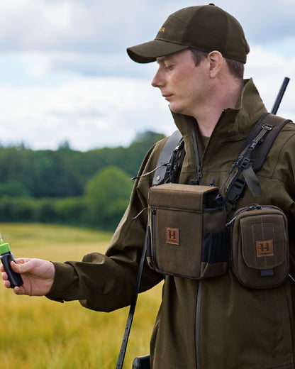 Dark Willow Green Coloured Harkila Utility Pouch on blurry background #colour_dark-willow-green
