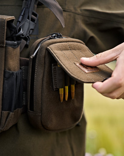 Dark Willow Green Coloured Harkila Utility Pouch on blurry background #colour_dark-willow-green