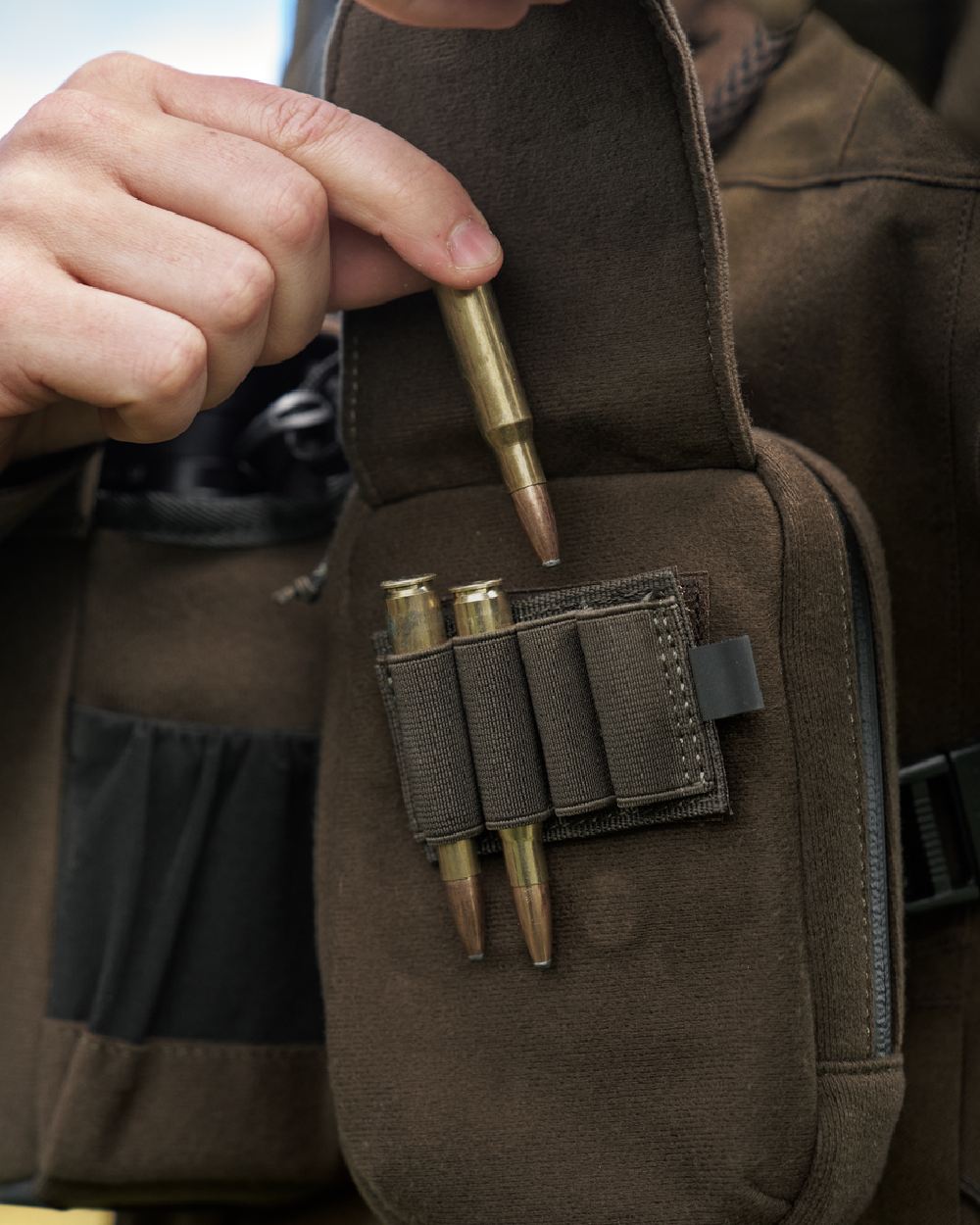 Dark Willow Green Coloured Harkila Utility Pouch on blurry background #colour_dark-willow-green