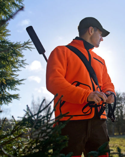 Orange Blaze Coloured Harkila Wildboar Pro Blaze Fleece Jacket on forest background #colour_orange-blaze