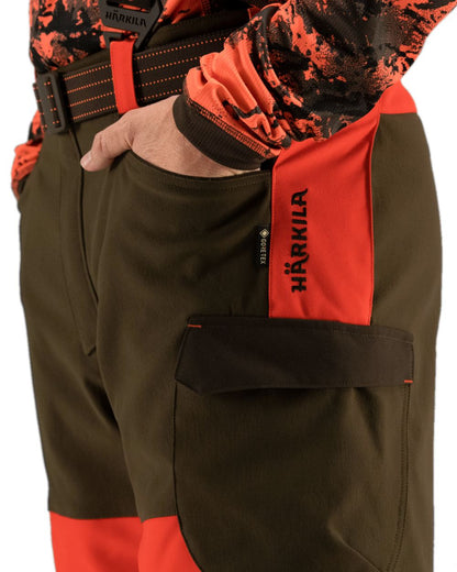 Wildboar Orange Willow Green Coloured Harkila Wildboar Pro Trousers on white background #colour_wildboar-orange-willow-green