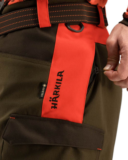 Wildboar Orange Willow Green Coloured Harkila Wildboar Pro Trousers on white background #colour_wildboar-orange-willow-green