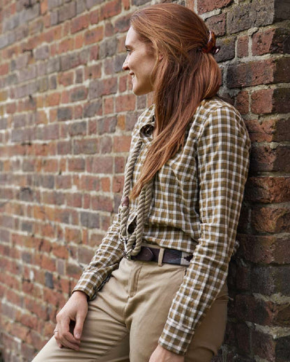Dark Olive Check Coloured Harkila Womens Fjell Long Sleeve Shirt on wall background #colour_dark-olive-check