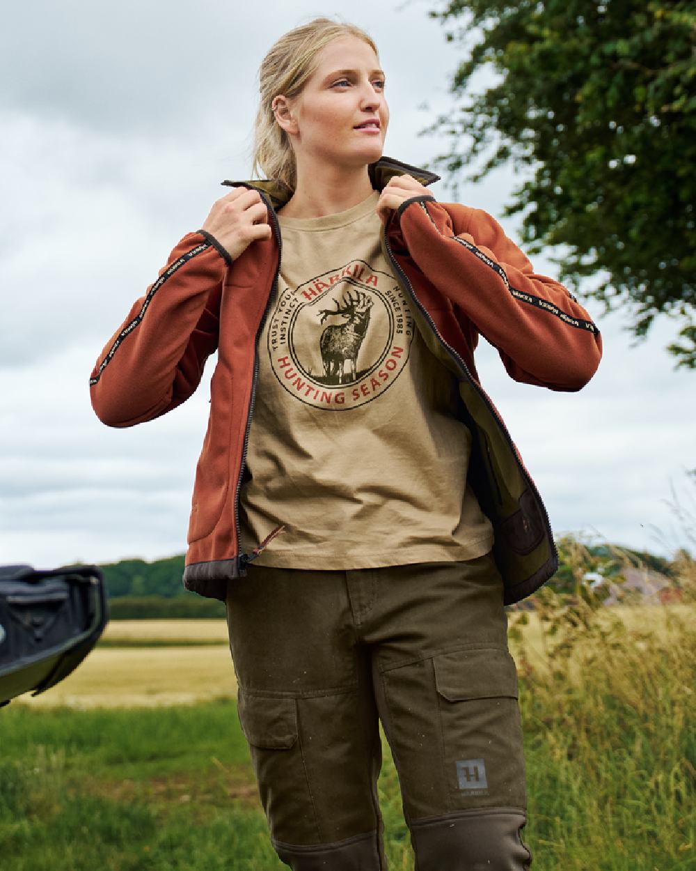 Dark Olive Arabian Spice Coloured Harkila Womens Kamko Reversible Windstopper Fleece Jacket on outdoor background #colour_dark-olive-arabian-spice