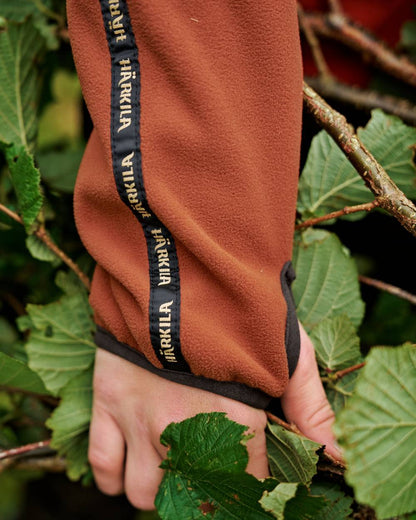 Dark Olive Arabian Spice Coloured Harkila Womens Kamko Reversible Windstopper Fleece Jacket on outdoor background #colour_dark-olive-arabian-spice
