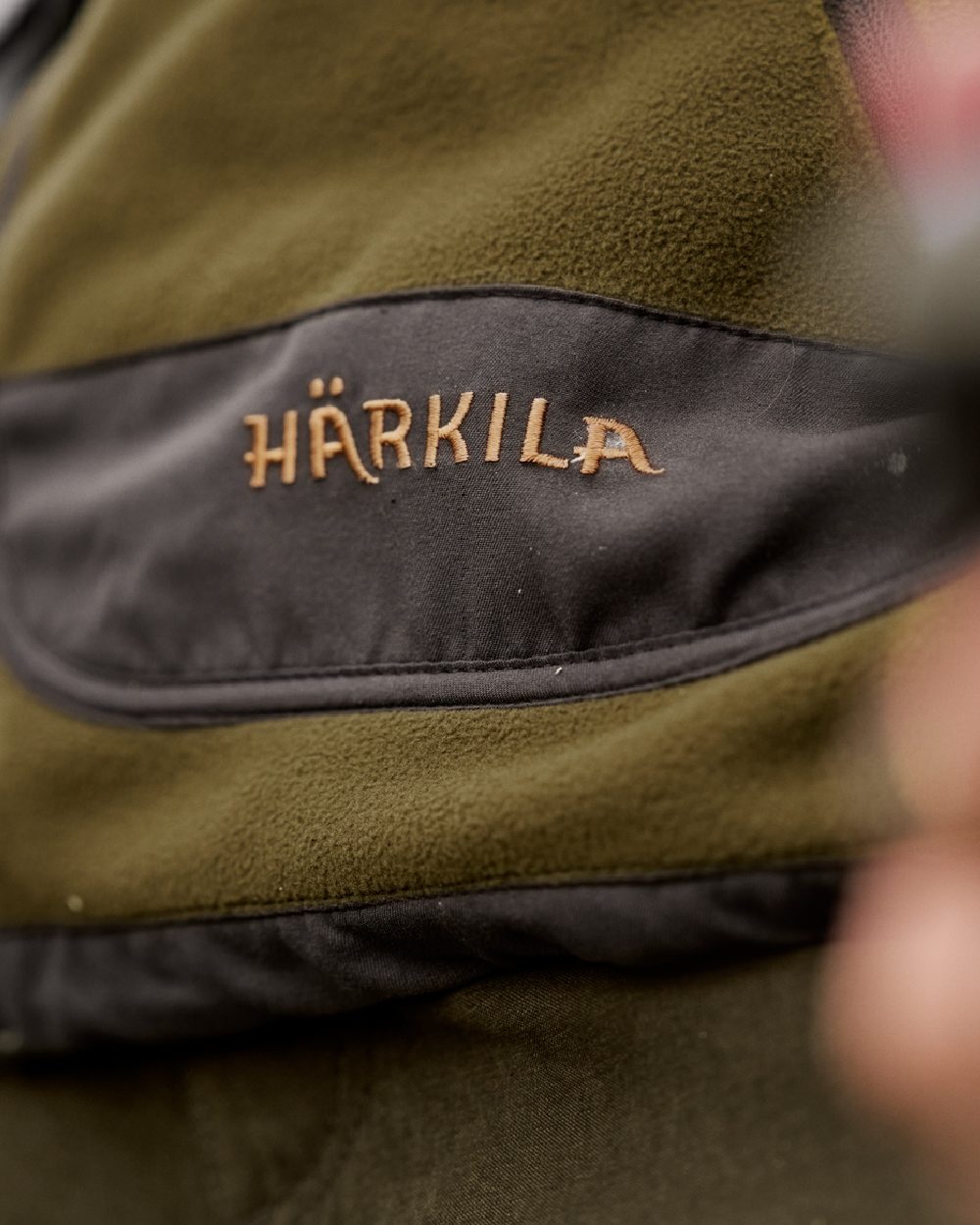 Dark Olive Arabian Spice Coloured Harkila Womens Kamko Reversible Windstopper Fleece Jacket on outdoor background #colour_dark-olive-arabian-spice