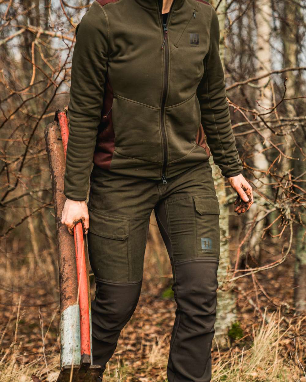 Willow Green Deep Brown coloured Harkila Womens Scandinavian Trousers on forest background #colour_willow-green-deep-brown