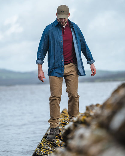 Dark Wash Coloured Hoggs of Fife Archerfield Denim Shirt on coastal background #colour_dark-wash