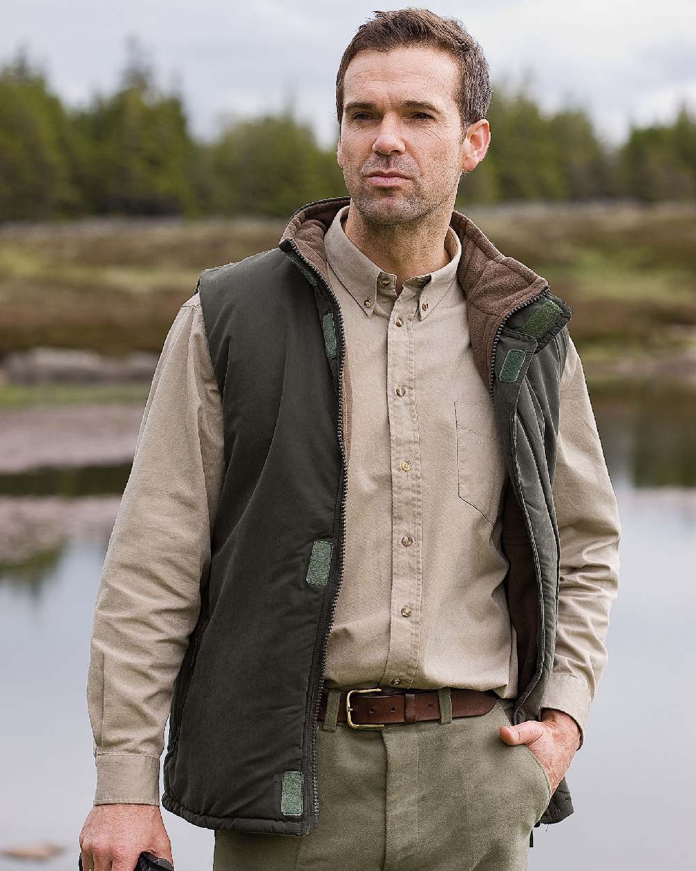 Loden Green Coffee Coloured Hoggs of Fife Breezer II Reversible Bodywarmer on lake background #colour_loden-green-coffee