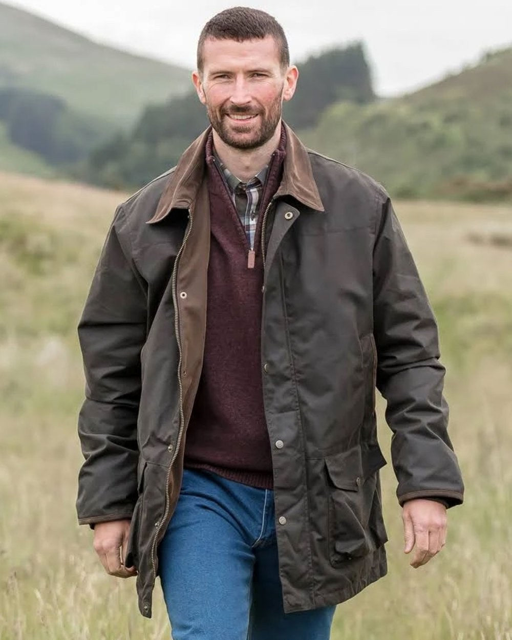 Olive Coloured Hoggs of Fife Caledonia Waxed Jacket on blurry background #colour_olive