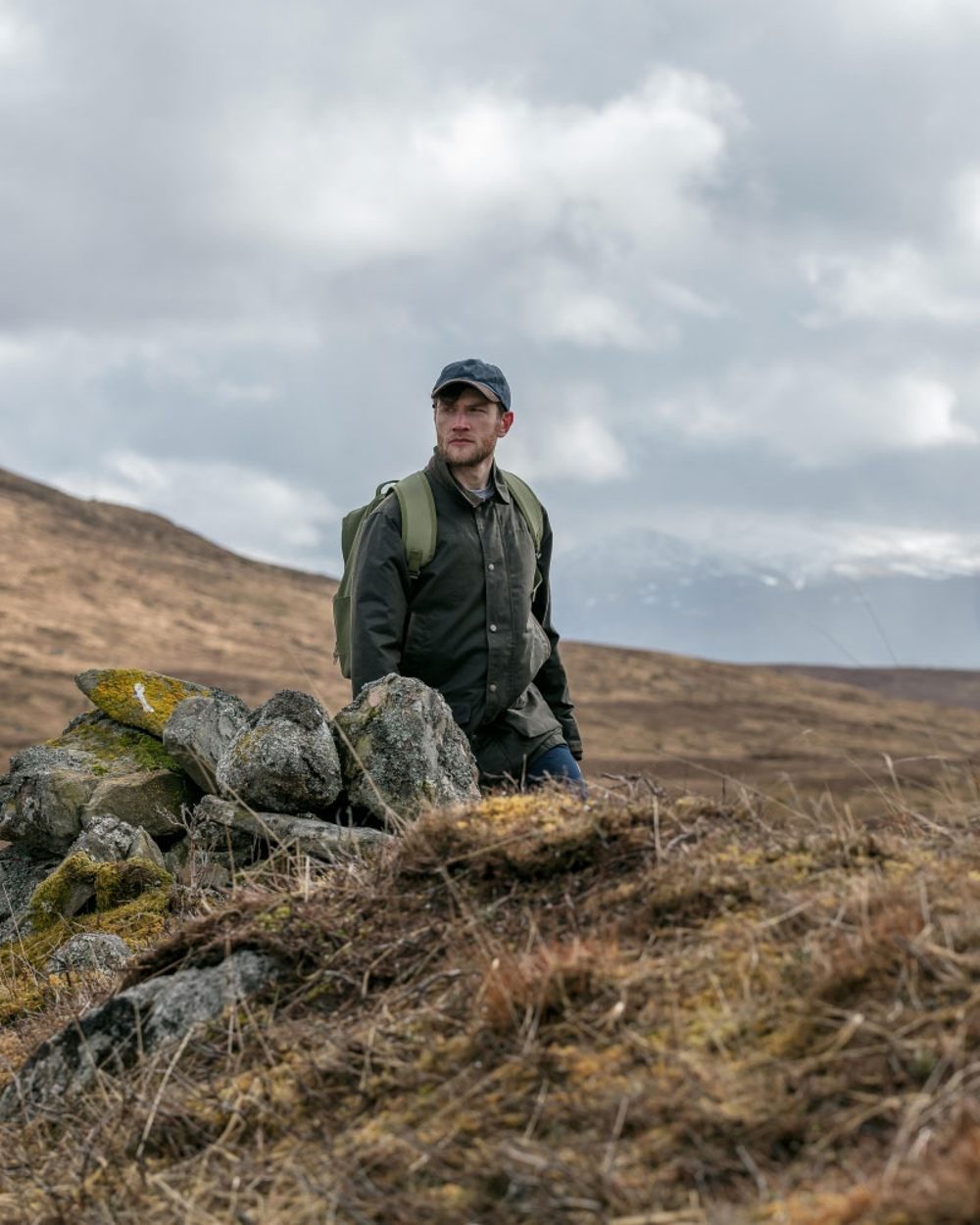 Olive Coloured Hoggs of Fife Caledonia Waxed Jacket on mountain background #colour_olive