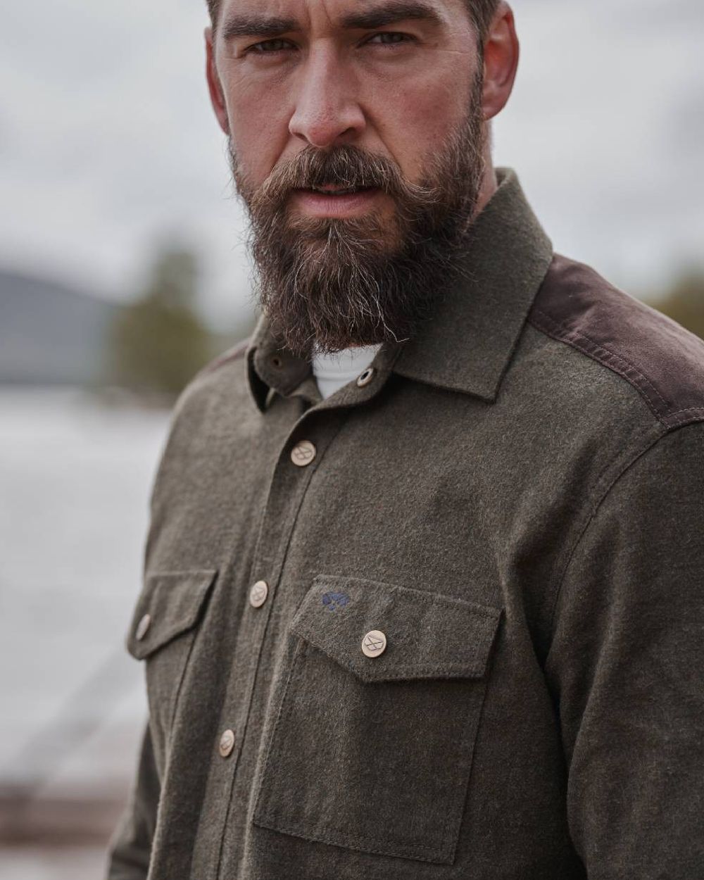 Loden Marl Coloured Hoggs of Fife Dunvegan Flannel Shirt on blurry background #colour_loden-marl