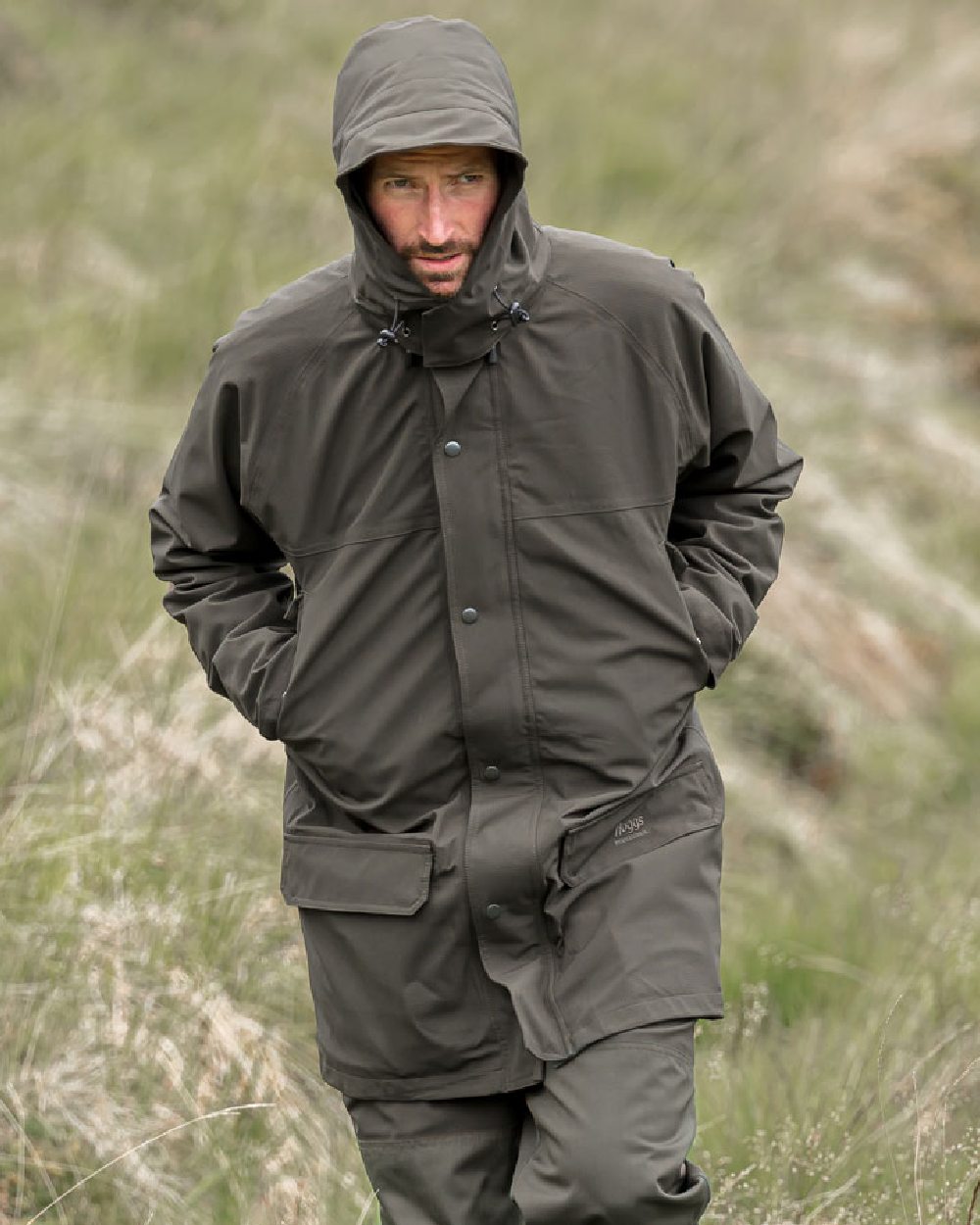 Green Coloured Hoggs of Fife Green King II Waterproof Jacket on grass background #colour_green