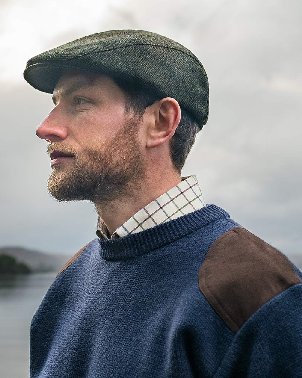 Green Coloured Hoggs of Fife Herringbone Waterproof Tweed Flat Cap on sky background #colour_green