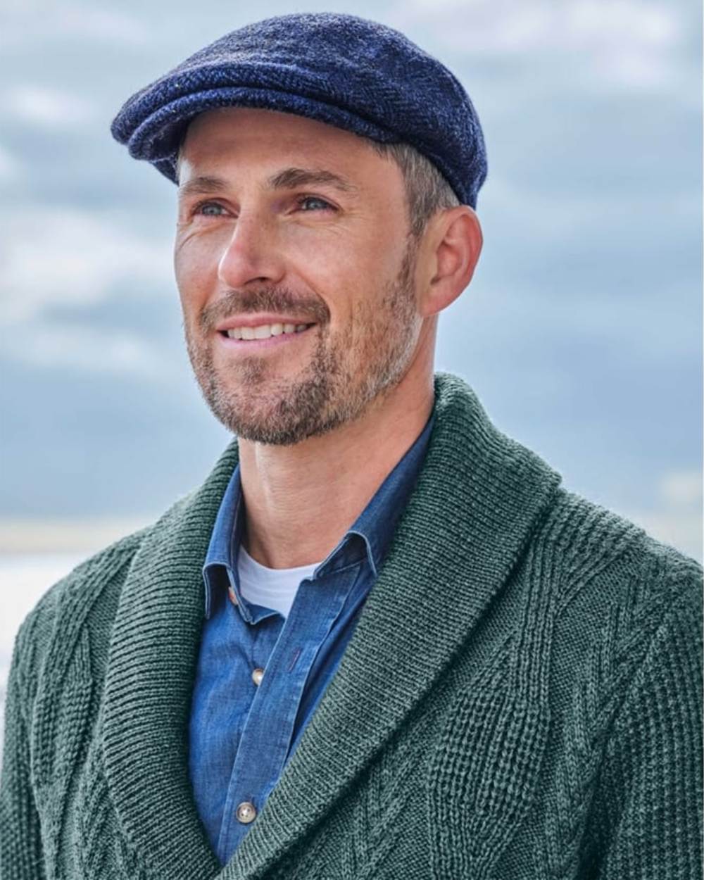 Navy Coloured Hoggs of Fife Herringbone Waterproof Tweed Flat Cap on sky background #colour_navy