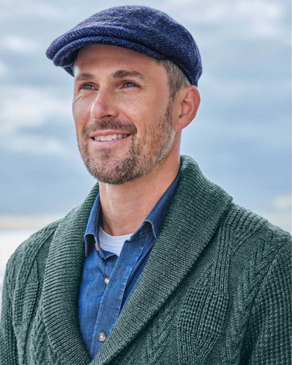 Navy Coloured Hoggs of Fife Herringbone Waterproof Tweed Flat Cap on sky background #colour_navy