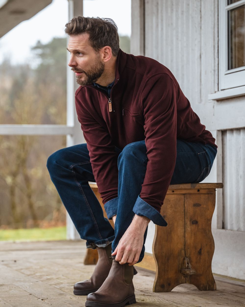 Burgundy coloured Hoggs of Fife Islander 1/4 Zip Micro Fleece Shirt on house background #colour_burgundy