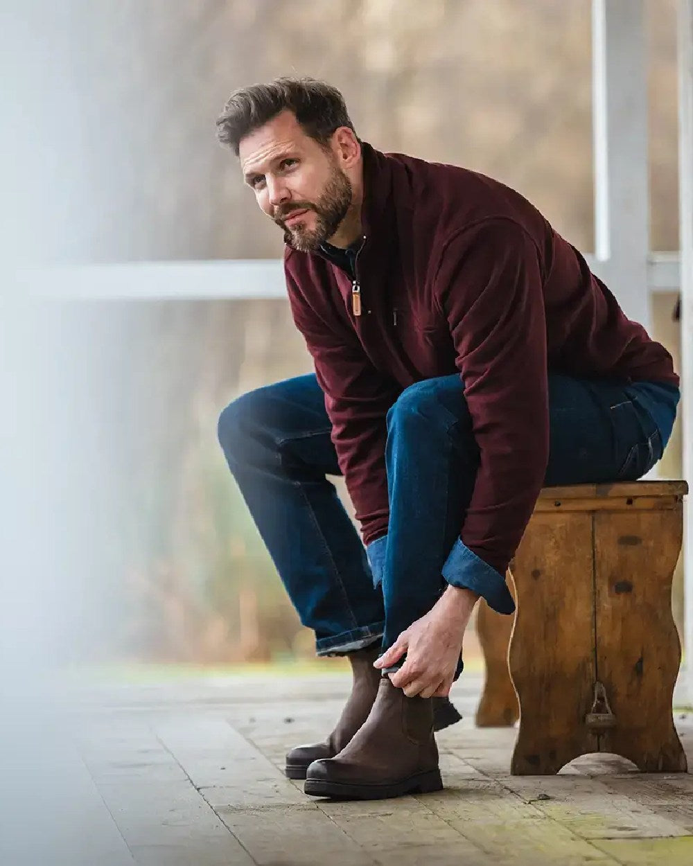 Burgundy coloured Hoggs of Fife Islander 1/4 Zip Micro Fleece Shirt on blurry background #colour_burgundy