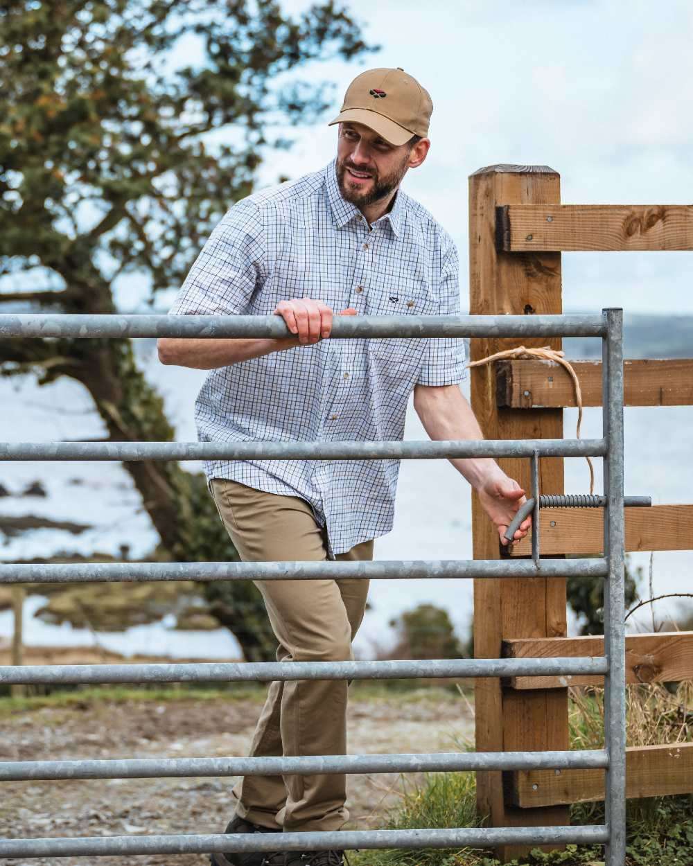 Brown Blue Coloured Hoggs of Fife Kessock Tattersall Short Sleeved Shirt on coastal background #colour_brown-blue