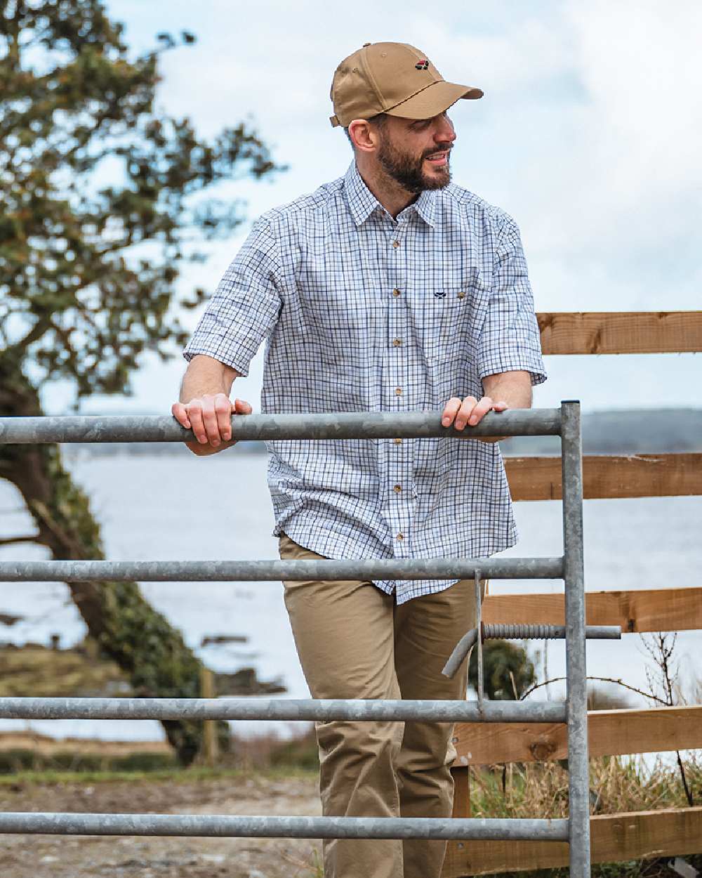 Green Red Coloured Hoggs of Fife Kessock Tattersall Short Sleeved Shirt on coastal background #colour_green-red
